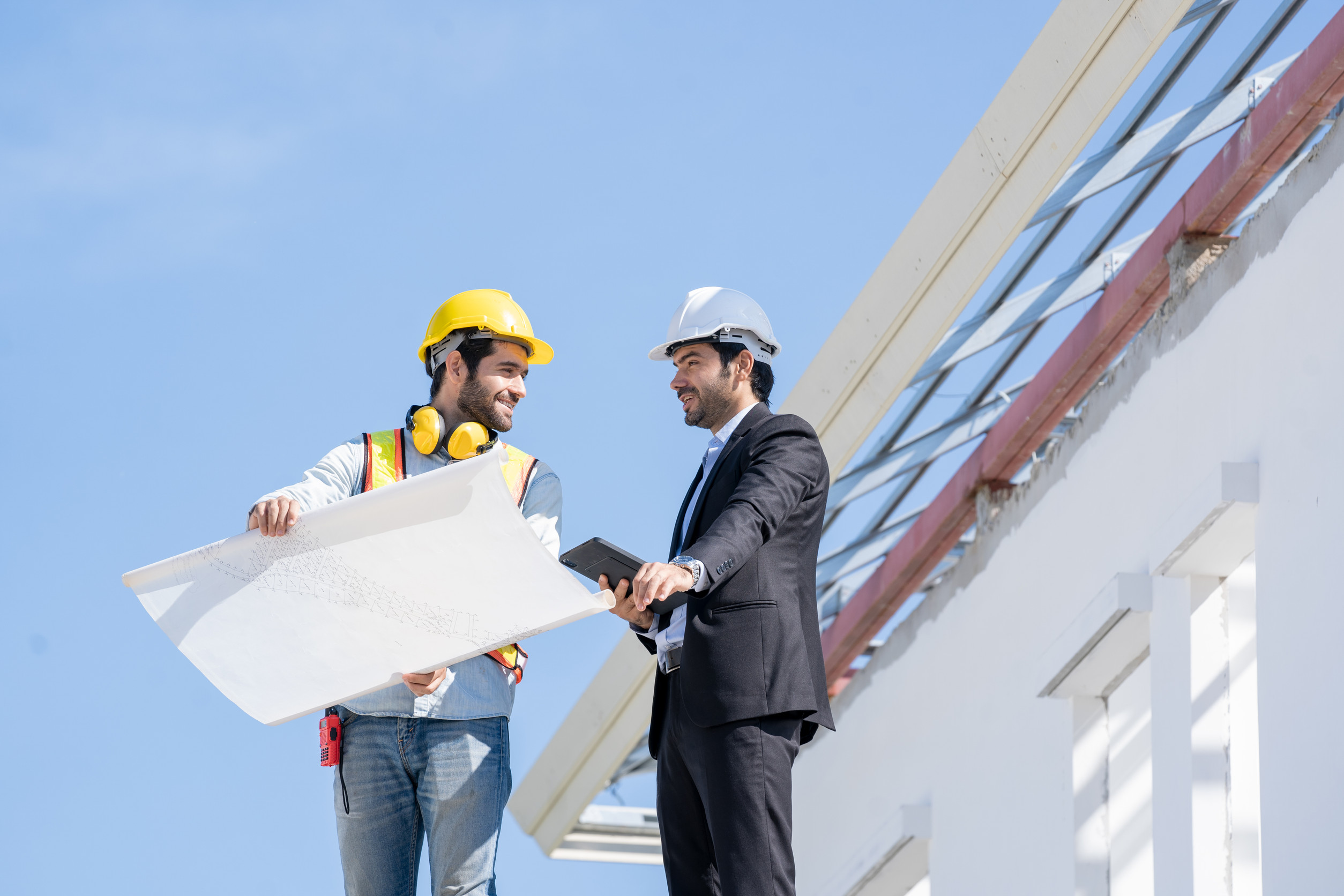 Architects discuss with head engineer about construction project Roofing Company